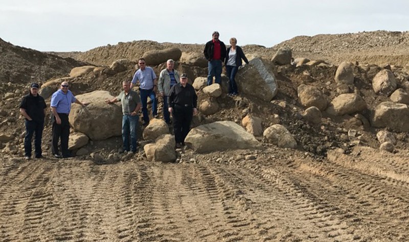 council standing in gravel pit