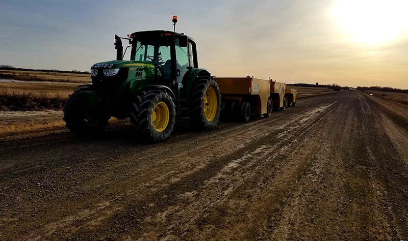 john deere tractor driving down dirt road